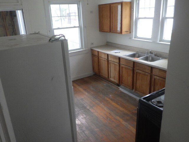 kitchen with black range with electric stovetop, sink, and dark hardwood / wood-style flooring