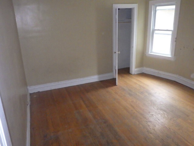 spare room featuring dark hardwood / wood-style flooring