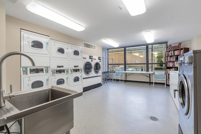 laundry area featuring stacked washer / dryer and washing machine and clothes dryer