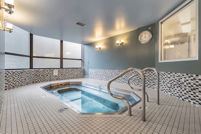 view of swimming pool with an indoor hot tub