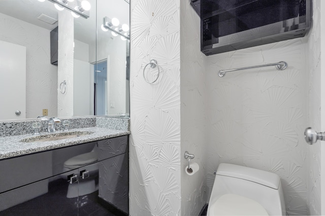 bathroom with vanity and toilet