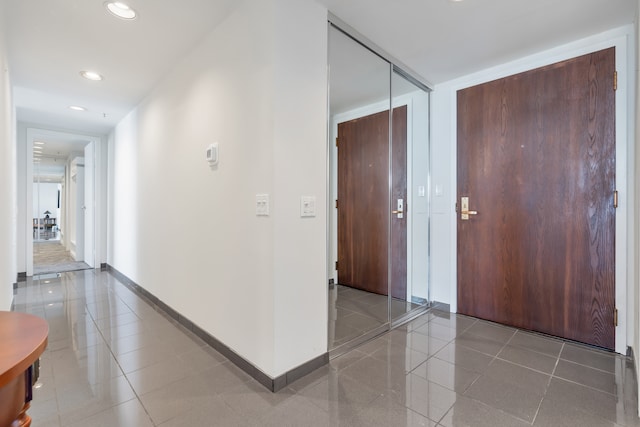 hall with tile patterned flooring