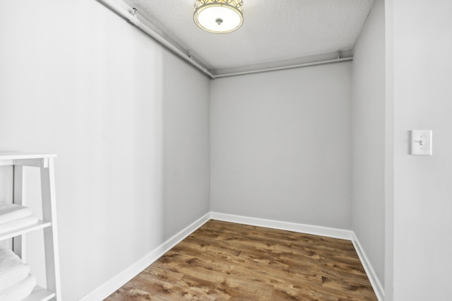 spare room featuring a textured ceiling and hardwood / wood-style floors