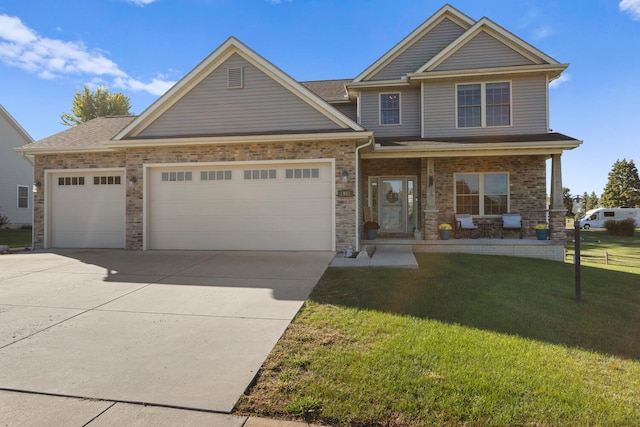 craftsman house featuring a front yard and a garage