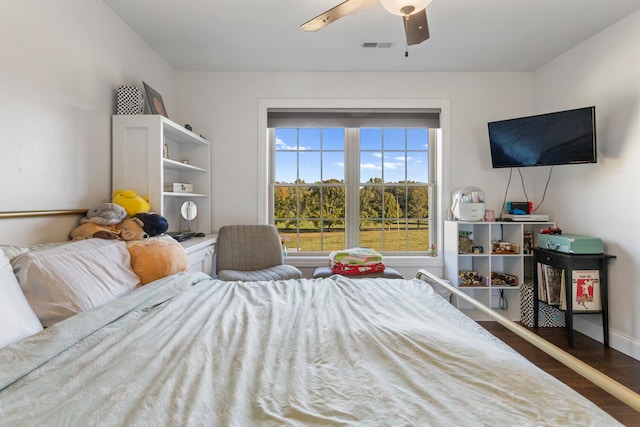 bedroom with ceiling fan and dark hardwood / wood-style floors