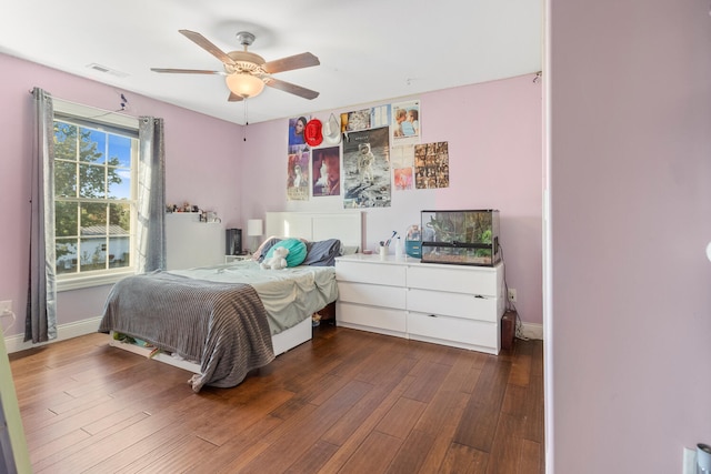 bedroom with ceiling fan and dark wood-type flooring