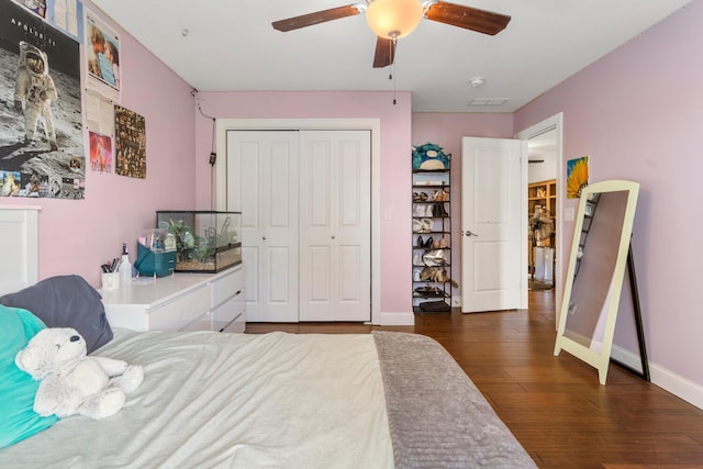 bedroom with a closet, ceiling fan, and dark hardwood / wood-style floors