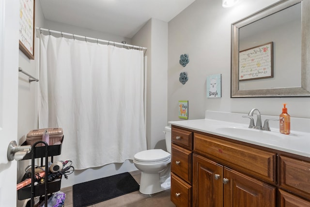 bathroom with curtained shower, tile patterned flooring, vanity, and toilet