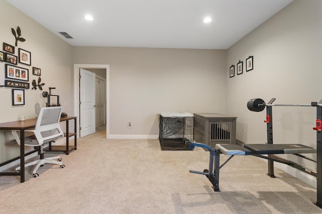 workout room featuring light colored carpet