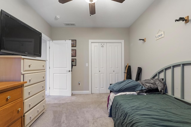 carpeted bedroom featuring a closet and ceiling fan