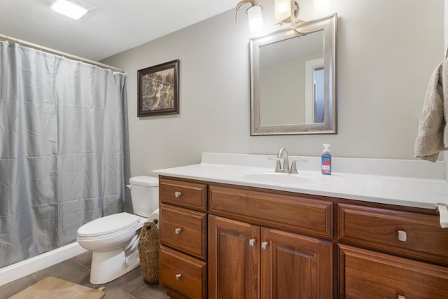 bathroom with a shower with curtain, vanity, toilet, and tile patterned floors