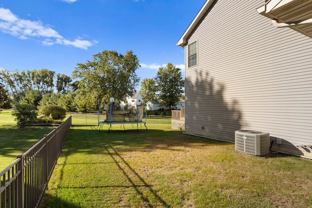 view of yard with cooling unit and a trampoline