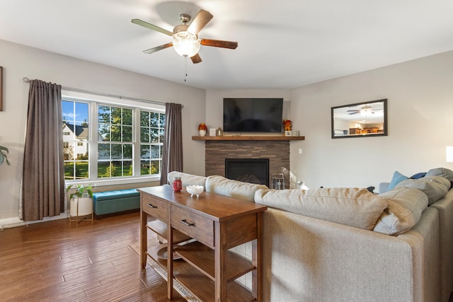 living room featuring ceiling fan and dark hardwood / wood-style flooring