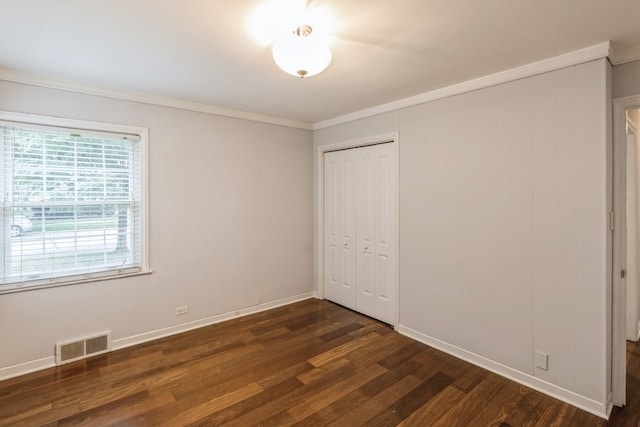 unfurnished room featuring ornamental molding and dark hardwood / wood-style floors