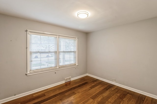 empty room featuring dark hardwood / wood-style flooring