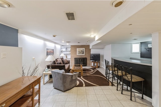 tiled living room with a fireplace