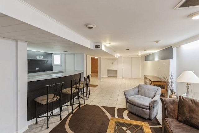 living room featuring bar area and light tile patterned floors