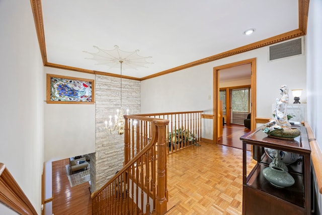 hall with ornamental molding and light parquet floors