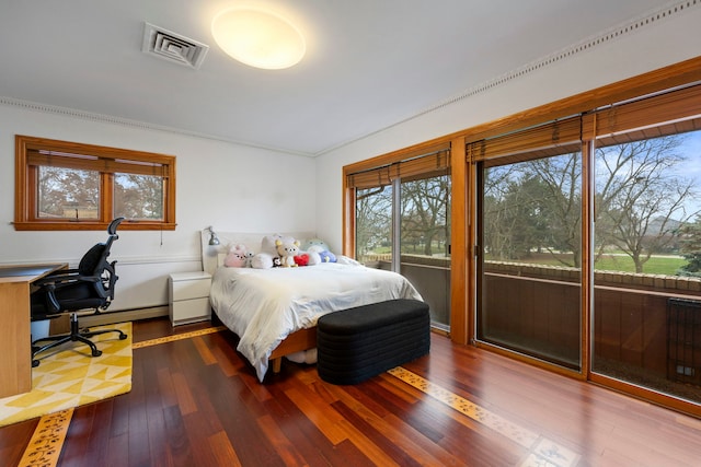 bedroom with access to outside, hardwood / wood-style flooring, and crown molding