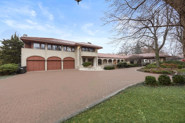 mediterranean / spanish-style home with a garage