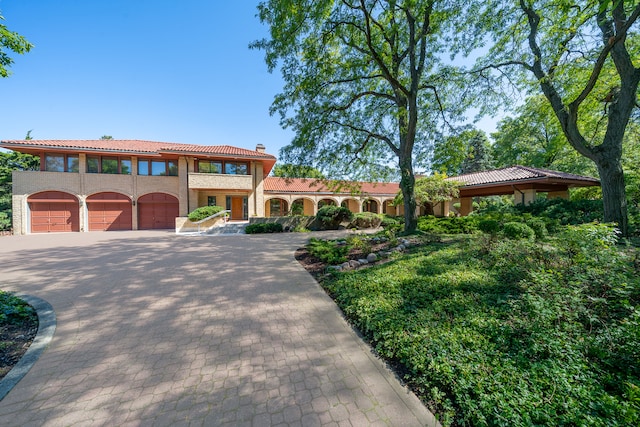 mediterranean / spanish-style home featuring a garage