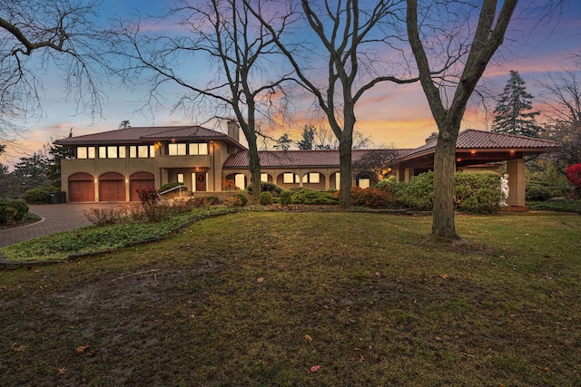 view of front of home with a lawn and a garage