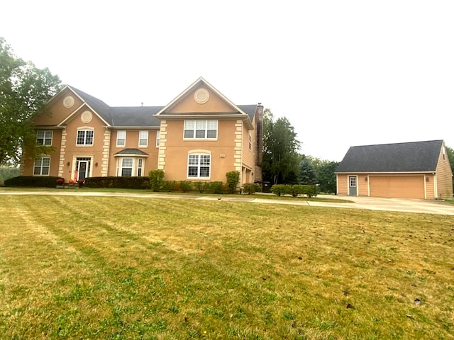 view of front of property featuring a front yard and a garage