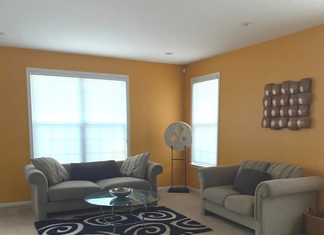 carpeted living room featuring plenty of natural light