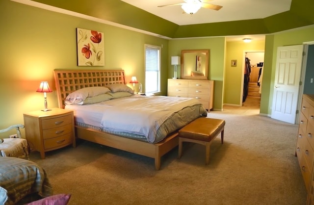 carpeted bedroom featuring ceiling fan and a closet