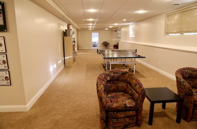 recreation room with light colored carpet