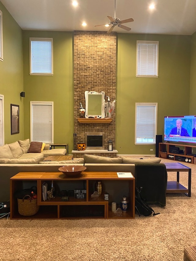 interior space featuring ceiling fan and a brick fireplace