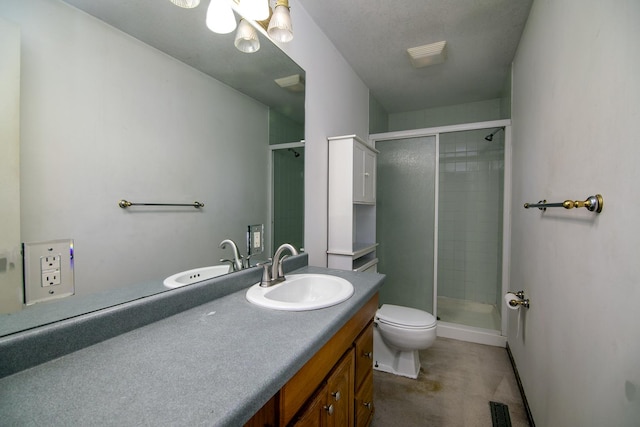 bathroom featuring a shower with door, toilet, and vanity