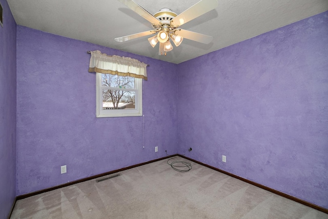 spare room with light carpet and ceiling fan