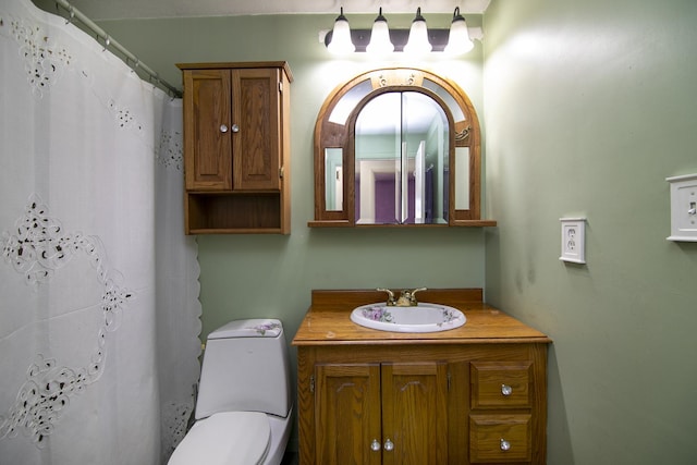 bathroom with toilet, vanity, and a shower with shower curtain