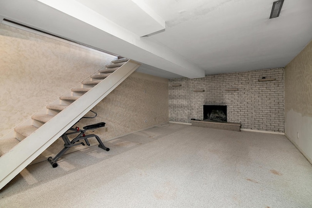 basement with a brick fireplace and carpet