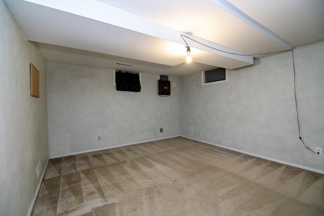 basement featuring light carpet