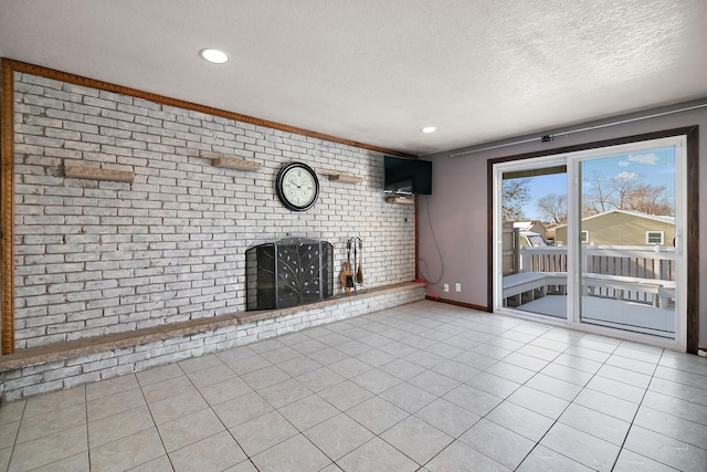 unfurnished living room featuring brick wall, light tile patterned floors, and a textured ceiling