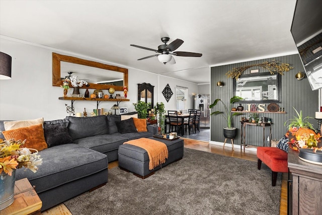 living room with hardwood / wood-style floors, ceiling fan, and crown molding