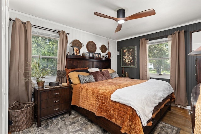 bedroom with ceiling fan, dark wood-type flooring, and ornamental molding