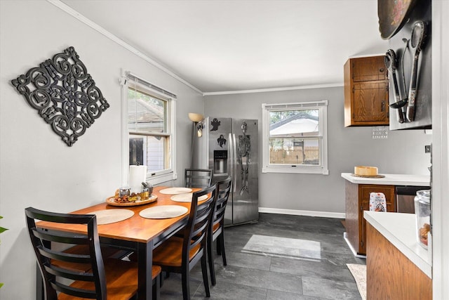 dining space featuring plenty of natural light and ornamental molding