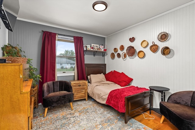 bedroom featuring hardwood / wood-style flooring and ornamental molding