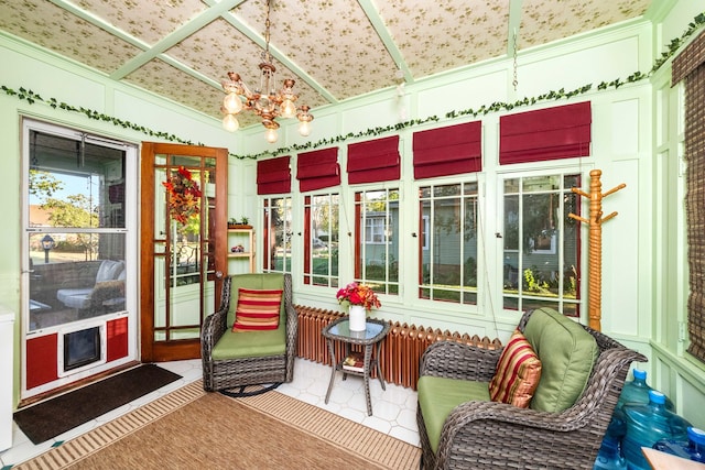 sunroom with an inviting chandelier and vaulted ceiling