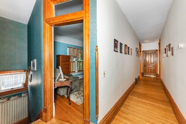 corridor with light hardwood / wood-style flooring