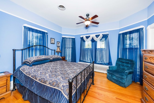 bedroom with hardwood / wood-style floors and ceiling fan