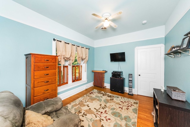 living room with hardwood / wood-style floors and ceiling fan