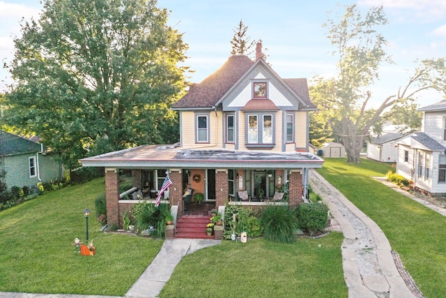 view of front of property with a porch and a front yard