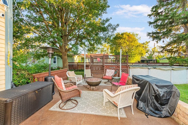 view of patio featuring area for grilling, a fire pit, and a wooden deck