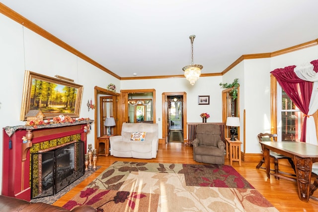 living room featuring ornamental molding, a fireplace, and hardwood / wood-style floors