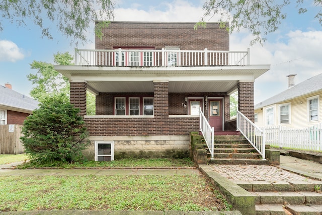 view of front of property featuring a balcony