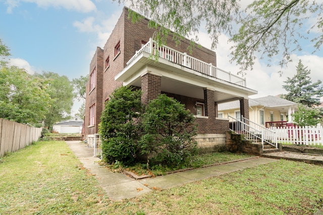 view of side of property with a lawn